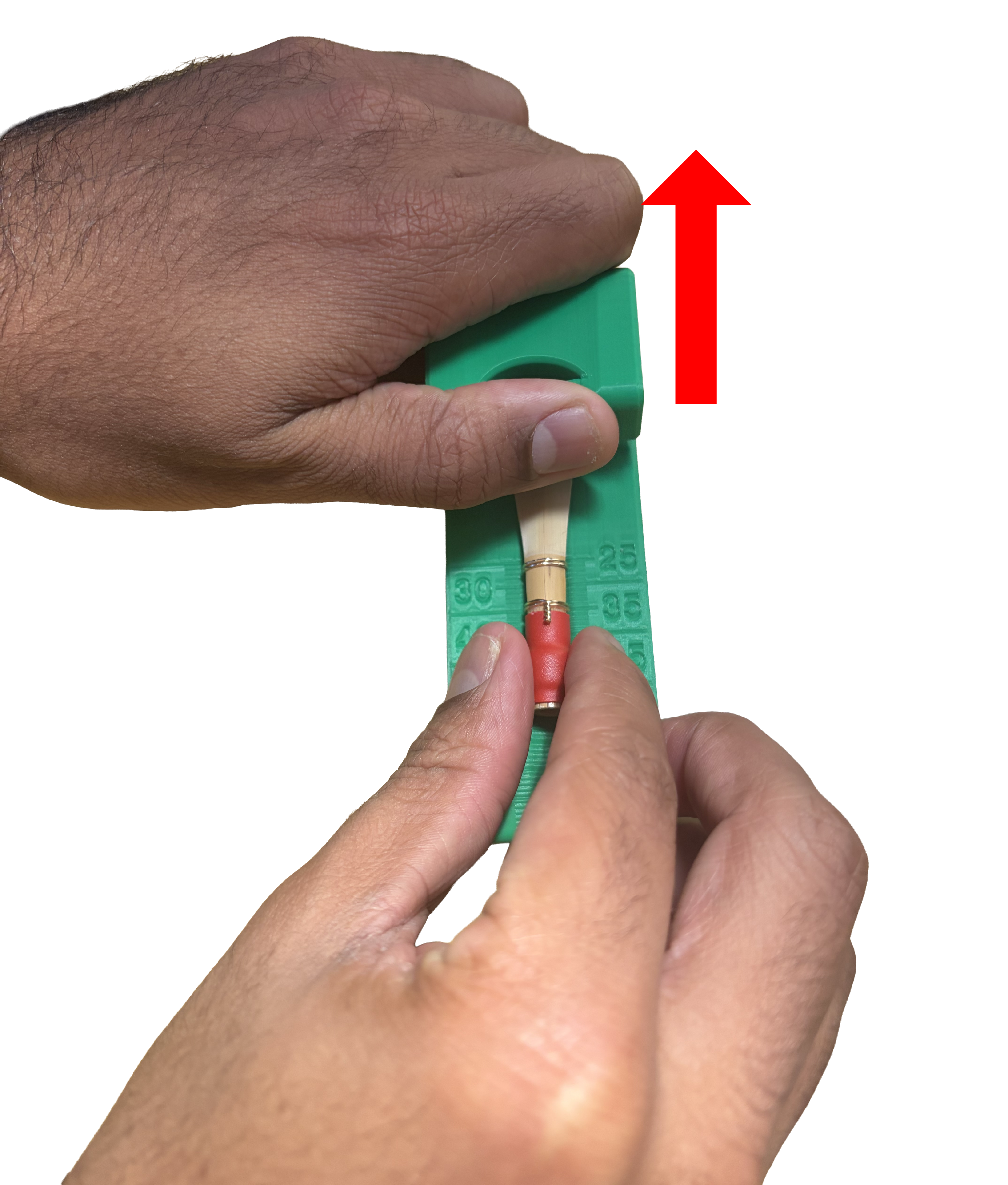 Hand placement to open the guillotine opening while aligning reed.